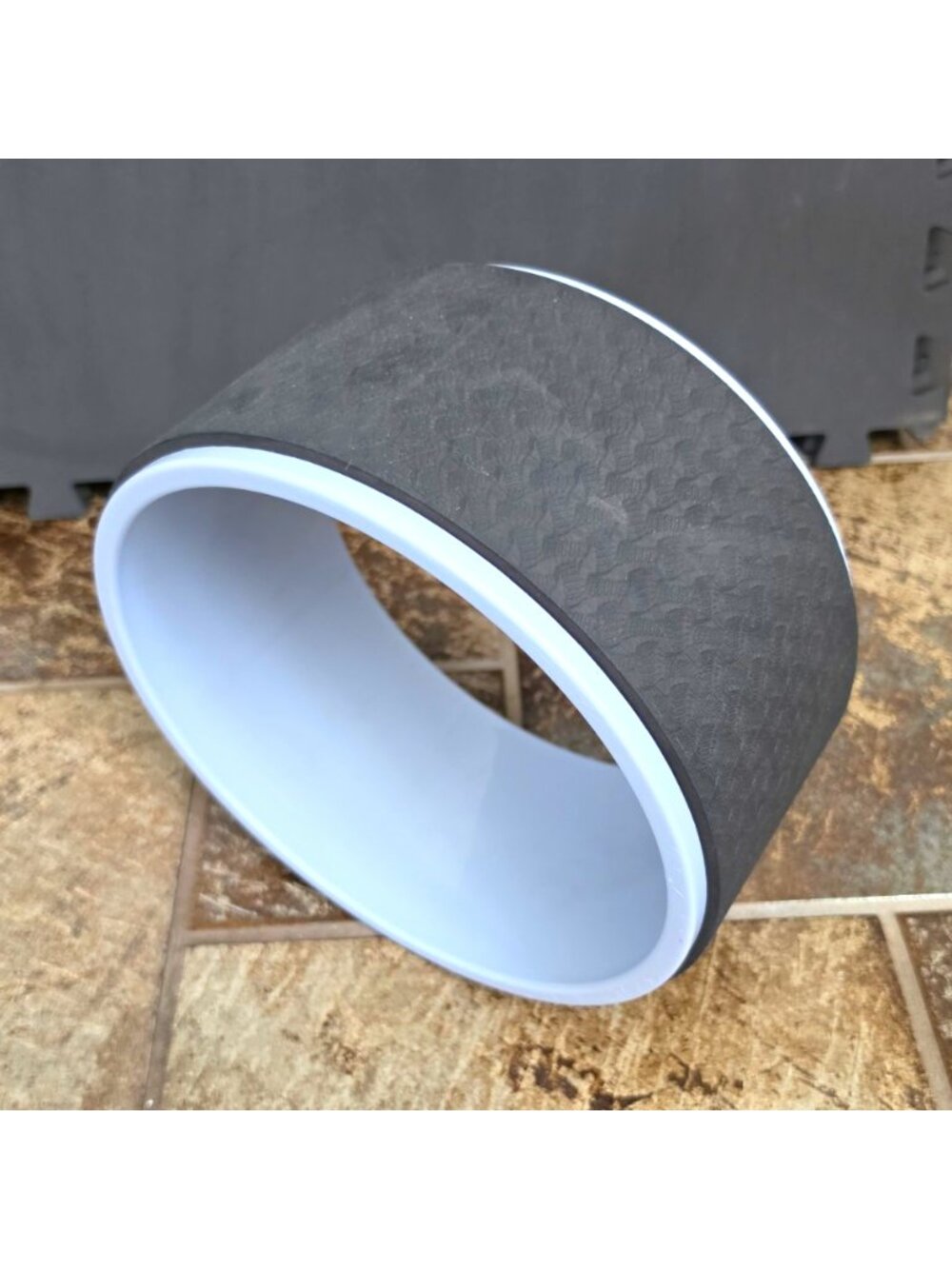 yoga wheel (also commonly referred to as a yoga back roller or dharma yoga prop)